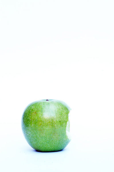 Green apple with bite.
