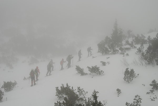 Trekking in snow in foggy weat