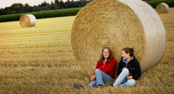 Two Girls sitting in Field wit