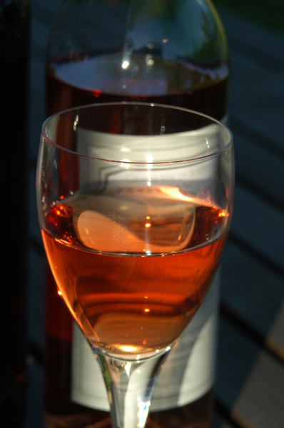 A glass of rose wine playing w