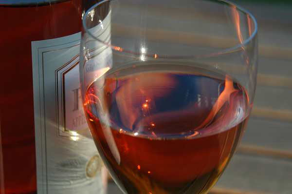 A glass of rose wine playing w