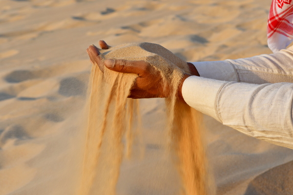 Sand in the hand of an Indian