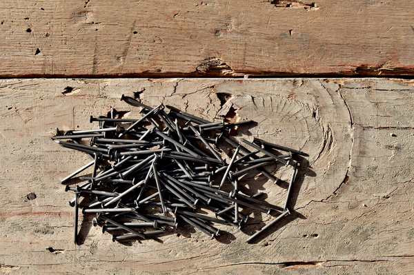 steel nails on wooden deck