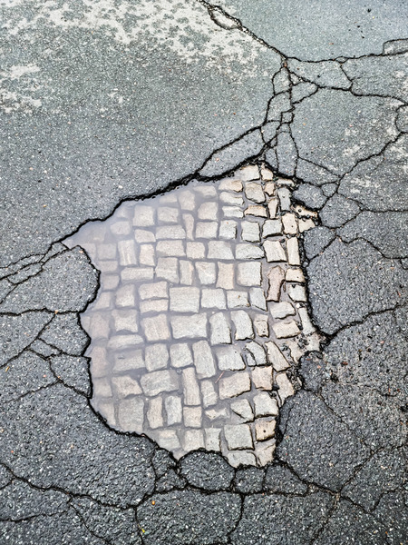 stony puddle in asphalt