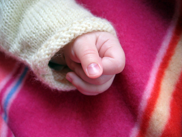 Little hand: baby hand on a blanket
