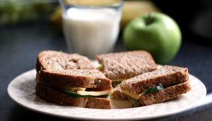 healthy lunch: cheese cucumber sandwich, milk and apple