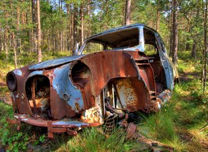 Disintegration - HDR: Old car in a forest in Sweden. The car is, I believe, an old Saab. The picture is HDR using five images.