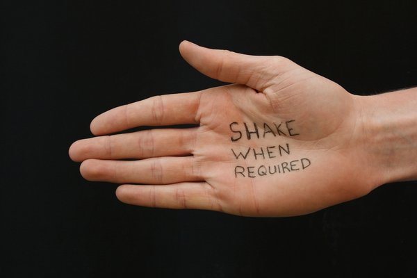 Shake When Required: Outstretched white hand with message, friendship help concept