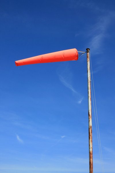 Windsock: An orange coloured aviation windsock against a blue sky
