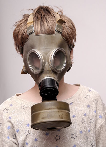 Boy in the soviet gas mask  1: Mask worn over the face to protect the wearer from inhaling airborne pollutants and toxic materials