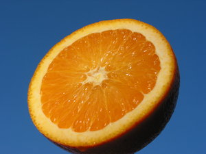 Orange and Blue 3: Natural high contrast - crisp and fresh orange with blue sky background. Put the orange on a metal stick and held it up against the evening sky slightly tilted towards the sunlight.