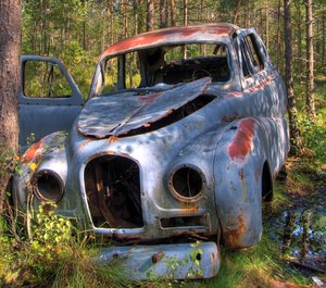 Disintegration - HDR: Old car sitting in a forrest for 50 years. The picture is HDR derived from five individual pictures.