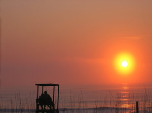 Lovers Dawn: Sorry, another sunrise, but I couldn't resist! A close couple enjoying the break of a new day on a lifeguard seat at the beach. Original - renamed