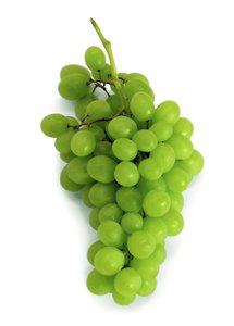 Grapes: Green grapes, isolated on white background.
