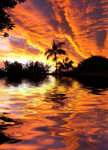 Tropical Waters 2: Spectacular sunset (the colours are not intensified) over tropical waters. Photo and graphic.
