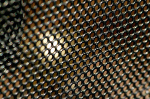 Speaker Grill: Close up of a speaker grill on a portable radio.