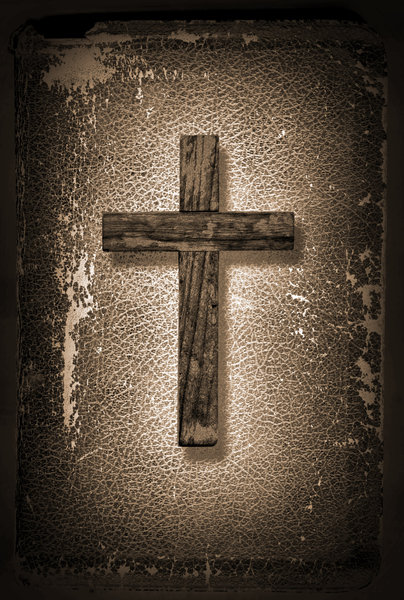 Cross and Bible: A wood cross on a vintage Bible.http://www.dailyaudiobibl ..Please visit my stockxpert gallery:http://www.stockxpert.com ..