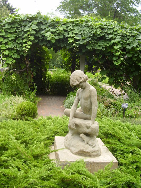The statue in the garden 5: A statue in the Denver Botanic Gardens. You wouldn't know it by looking at this place, but it's not easy to get a lot of things to grow here. There's a high altitude and it's very dry. 
