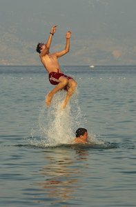Young boys jumping in the sea