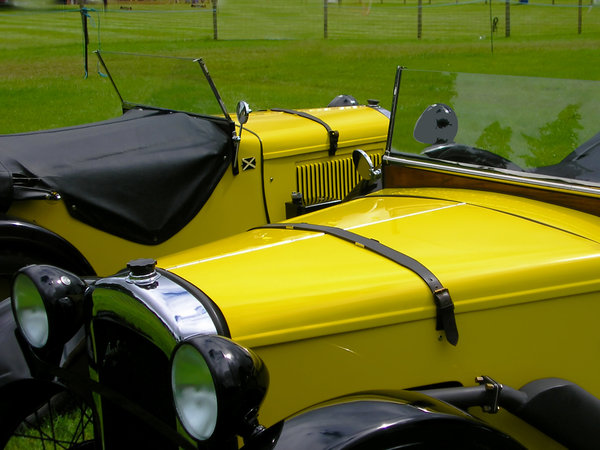 Two vintage cars: Two yellow cars