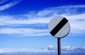 No Limits: Speed limits sign against cloudy blue sky.