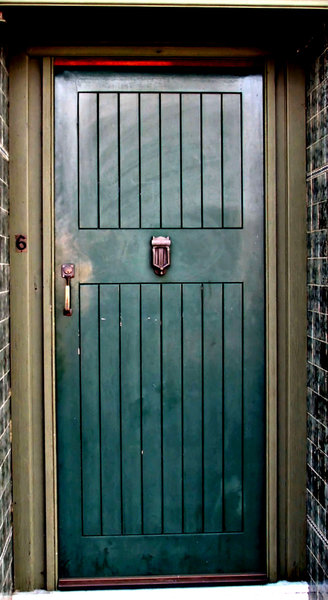green corner door: green wooden door of house on street corner