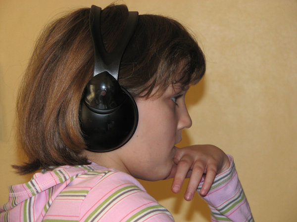listen carefuly: girl listening through headphones