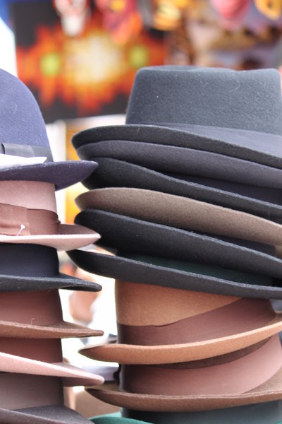 Hats: Piled hats on a market
