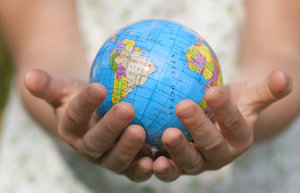 World care: globe in hands of little girl