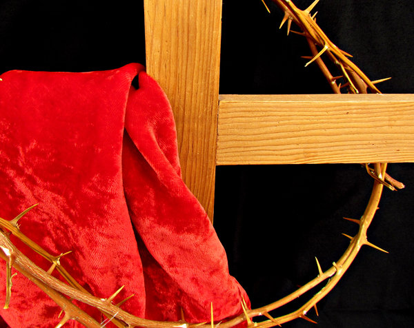 cross & crown of thorns: red cloth draped wooden cross and black background with crown of thorns