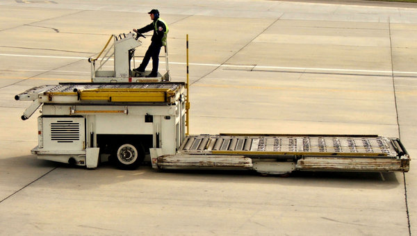 arrival readiness: tarmac trolleys lined up ready for unloading arriving aircraft