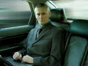 businessman: serious businessman in volvo s80, picture taken with Olympus C-2100 UZ, windows blurred in Photoshop.