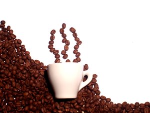 Hot coffee: Coffee beans as smoke from a cup of coffee