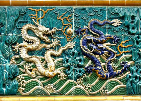 dragon wall: dragon decorated wall alongside public footpath