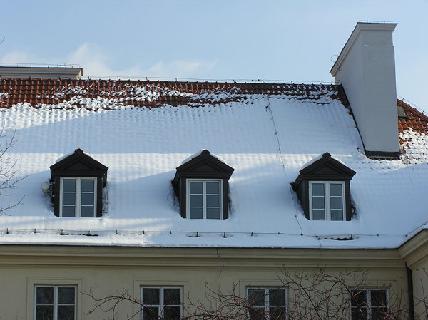 Snow on the roof: A snow on the roof of a building. With dormer (lukarna)