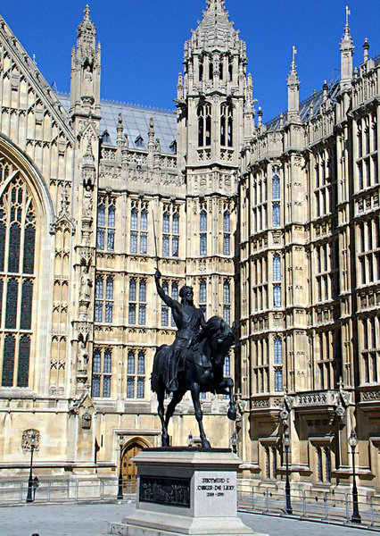 king richard 1: statue of richard the lion heart set against a backdrop of the houses of parliament london