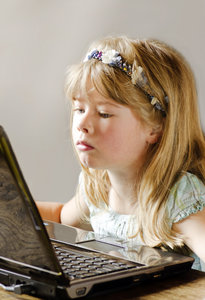 Child at computer: Little girl working on a laptop computer