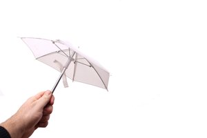 Holding small white umbrella