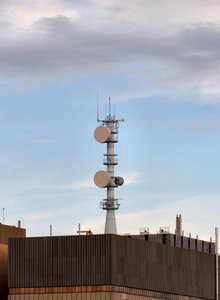 rooftop communications tower: communications tower atop city commercial highrise