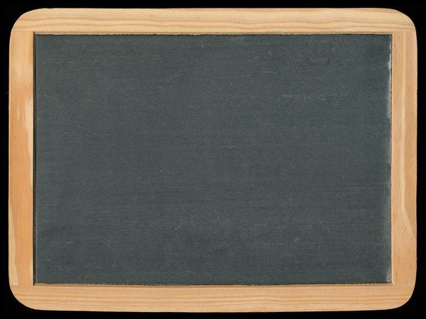 Vintage Chalkboard: Blank vintage chalkboard isolated on a black background.