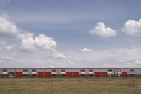 Regularity in industrial area: Nice clouds and red doors