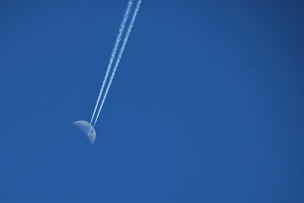 Airplane crossing the Moon: Airlainer crossing the Moon. Photo taken late afternoon.