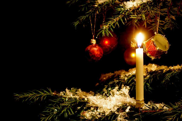 Christmas tree with candle: Christmas tree with candle and ornaments. Black background.