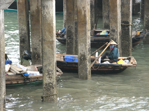 HALONG Bay: Locals on they daily routines... waiting for their turn to deliver stuff to the respective boats...