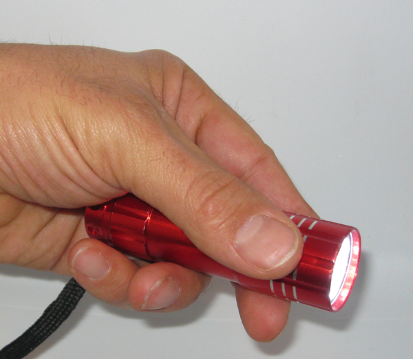 Hand with red flashlight
