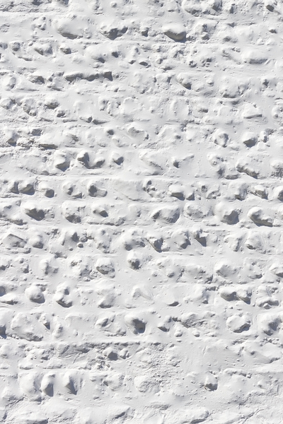 White wall texture: A rough cobblestone wall painted white.