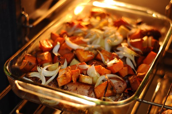 Roasted dinner: Potatoes and onions roasted in the oven with some chicken pieces