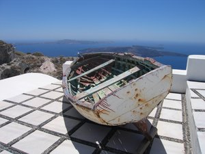 boat on roof: a boat on a roof high above the waterline in Santorini, Greece