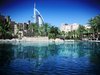 Architecture and reflection: View of the Burj al arab against the quaid madinat jumeirah. This is an architectural photograph                               
