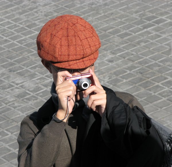 Snapping Tourist: A tourist taking photographs
